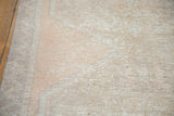 Distressed beige and apricot texture of a vintage Oushak rug runner's pile.