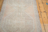 Distressed Oushak runner, worn texture in faded beige and soft apricot peach.