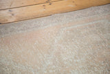 Distressed texture of the hand-knotted Oushak runner with soft beige and apricot hues.