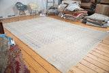Distressed vintage Turkish Oushak carpet with faded apricot field and royal blue repeating design.