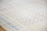 Distressed apricot field and faded royal blue patterns on the vintage Oushak rug's border.