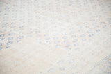 Distressed texture and repeating royal blue motifs on a faded apricot vintage Oushak rug.