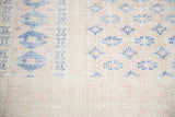 Faded royal blue geometric patterns and distressed texture of a vintage Turkish Oushak rug.