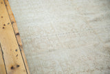 Textured distressed Oushak rug showing subtle faded floral design.
