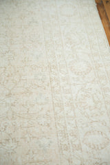 Textured hand-knotted pile of the distressed Oushak rug's subtle floral design.