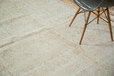 Distressed Oushak hand knotted rug pile with subtle beige and tan floral patterns.