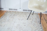 Distressed texture and geometric patterns on a vintage Oushak rug.