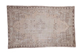 Distressed Oushak rug, large oblong medallion, ivory, beige, charcoal, and faded sea foam.