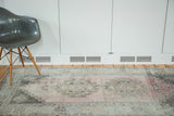 Distressed vintage Oushak rug featuring faded blush rose, grey, and ivory geometric patterns.