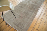 Distressed Oushak runner with muted earth tones and subtle geometric medallions.