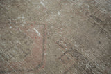 Distressed Oushak rug pile detail showing soft beige, ivory, and blush earth tones.