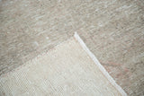 Close-up of distressed Oushak runner pile and hand-knotted back, featuring earthy beige with blush.