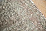 Distressed Oushak rug texture detail, with muted earthy beige, bark brown, and blush tones.