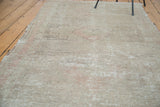 Faded beige, ivory, and soft blush tones showcasing the distressed Oushak rug runner texture.