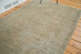 Distressed textured pile of a vintage Oushak rug with subtle neutral tones.