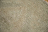 Textured pile of a distressed Oushak rug showing analogous neutral tones.