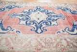 Distressed dusty faded cherry red Oushak field, unique parallel stripes, and muted border.