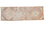 Distressed Turkish Oushak runner, faded cinnabar field, large tribal hook gul design in neutrals.