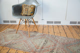Distressed Oushak runner showcasing faded cinnabar red and sea foam hook gul design.