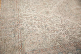Distressed Turkish Oushak carpet showing classic intricate patterns in antique ivory, blush, and blue.