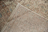 Distressed Oushak hand-knotted back, showing subtle weave and ivory, blush, blue tones.
