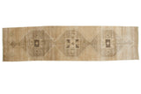 Distressed Oushak runner, triple geometric medallions, featuring beige, gold, and charcoal tones.