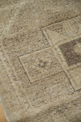 Textured close-up of the distressed Oushak rug runner's beige and soft charcoal geometric design.