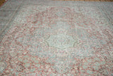 Distressed vintage Oushak pattern in blush rose, celadon green, and ivory.