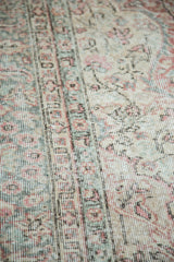 Distressed hand knotted Oushak carpet texture with celadon green and blush rose.