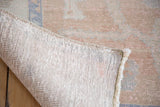 Vintage Oushak carpet's hand-knotted backing reveals distressed apricot and blue pile.