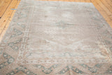 Distressed Oushak rug with faded patterns, soft green cloudbands, and subtle texture.