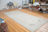 Distressed vintage Oushak runner featuring muted apricot peach and silver grey tones.