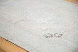 Exposed foundation and faded tones on a distressed Oushak runner, showing storied wear.