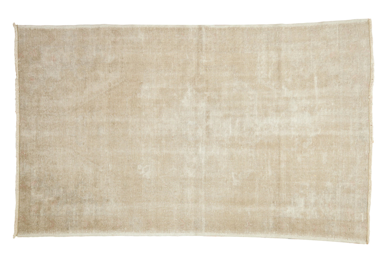 Hand-knotted distressed Oushak rug with muted ivory and beige tones, 4'4
