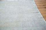 Distressed Oushak rug pile featuring faded ivory, beige, and soft rose hues.