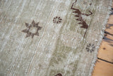 Distressed Oushak runner pile detail with faded moss green, ivory, and brown tribal star.