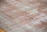 Distressed Oushak carpet showing faded brown texture and lighter patina.