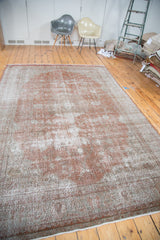 Distressed Turkish Oushak carpet edge, showing faded brown and gray hues with aged texture.
