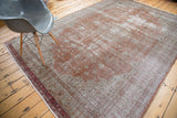 Distressed hand knotted Oushak rug texture in faded brown and forest green.
