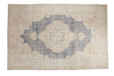 Distressed hand knotted Turkish Oushak carpet with large medallion, denim blue, ivory, mauve.