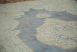 Distressed Oushak rug detail, soft denim blue field, ivory trefoil and floral motifs.