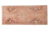 Vintage Oushak rug, dusty rose field, central medallion, beige and grey tree patterns.