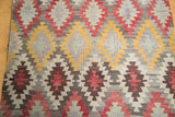 Hand woven geometric diamond pattern in saffron yellow, cinnabar red, ivory, and pewter.
