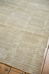 Distressed vintage Oushak rug shows its textured ivory and charcoal abstract geometric pattern.