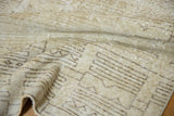 Distressed Oushak rug with textured pile and abstract geometric patterns in ivory, sage, charcoal.