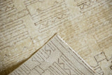 Modern geometric ivory and charcoal pattern, distressed Oushak rug with woven foundation.