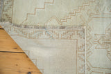 Distressed Turkish Oushak rug, showing hand-knotted construction and fringe.