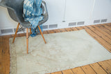 Vintage 1960s Distressed Oushak rug with faded geometric medallion and light neutral tones.