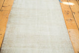 Distressed Oushak rug pile with a textured aesthetic in silver and platinum tones.