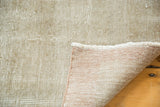 Textured grey and white distressed Oushak rug pile, fringe, and hand-knotted reverse.